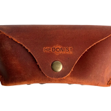 Soft Leather Eye Glasses Case in Cognac, closed, front view with embossed Hedonist logo and snap closure
