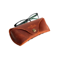 Soft Leather Eye Glasses Case in Cognac with black-framed eyeglasses resting on top