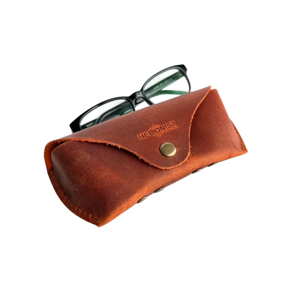 Soft Leather Eye Glasses Case in Cognac with black-framed eyeglasses resting on top