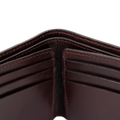Close-up of dark brown leather bifold wallet center fold and stitching