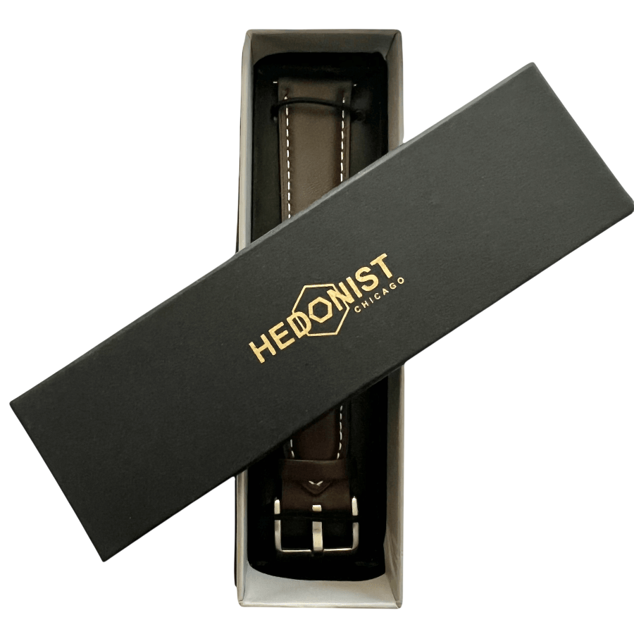 Dark brown leather watch band with quick release bars, texture close-up