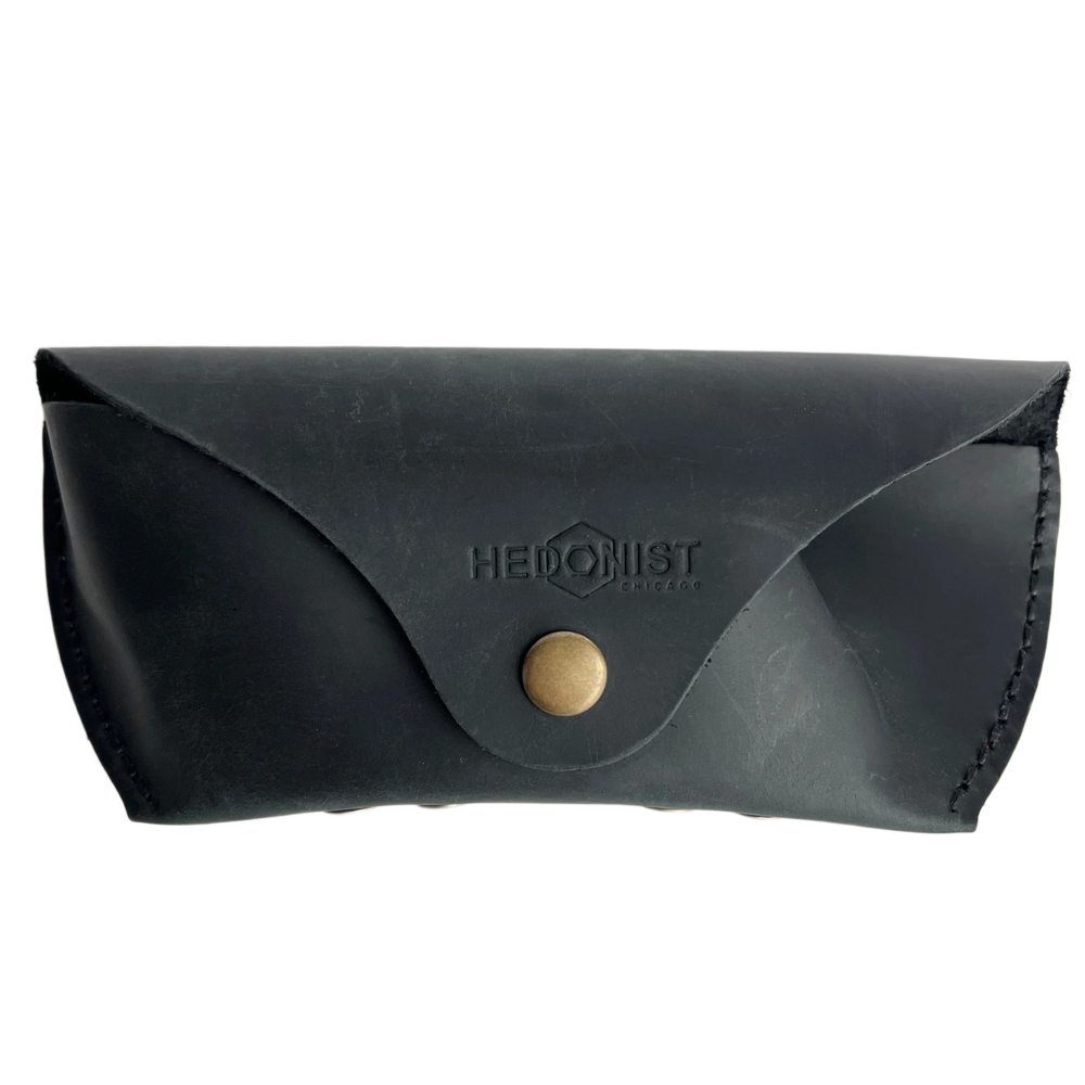Soft Leather Eye Glasses Case in Black, closed, front view with embossed Hedonist logo and snap closure