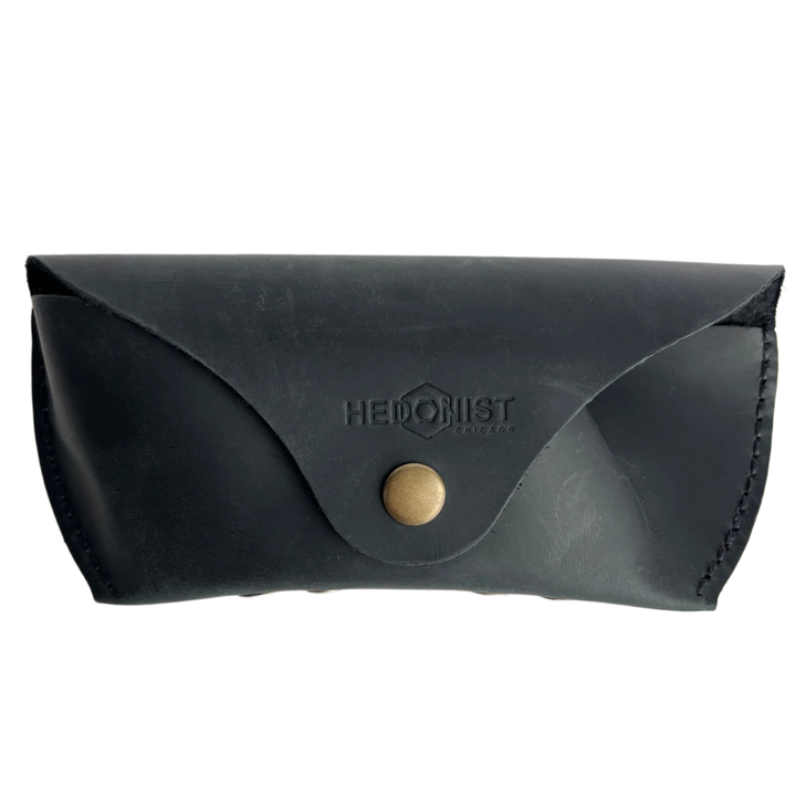 Soft Leather Eye Glasses Case in Black, closed, front view with embossed Hedonist logo and snap closure
