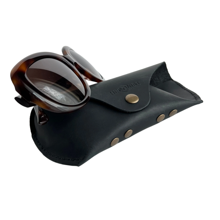 Soft Leather Eye Glasses Case in Black with tortoiseshell sunglasses leaning against it