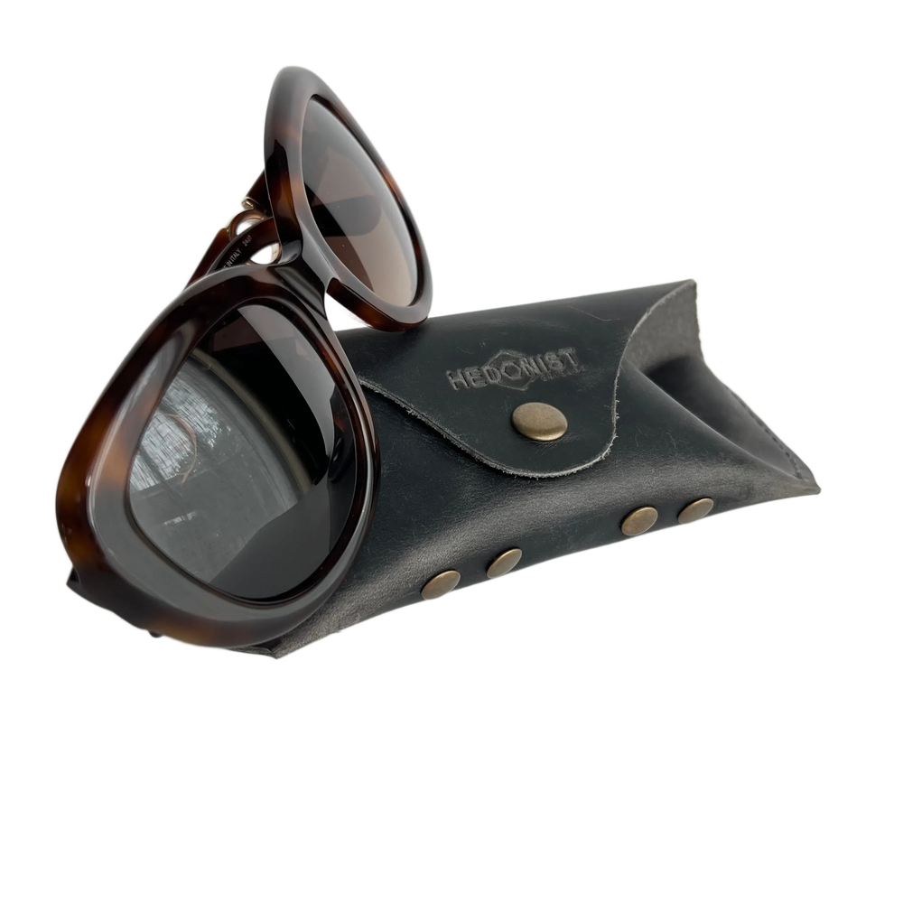 Soft Leather Eye Glasses Case in Black Washed with tortoiseshell sunglasses leaning against it