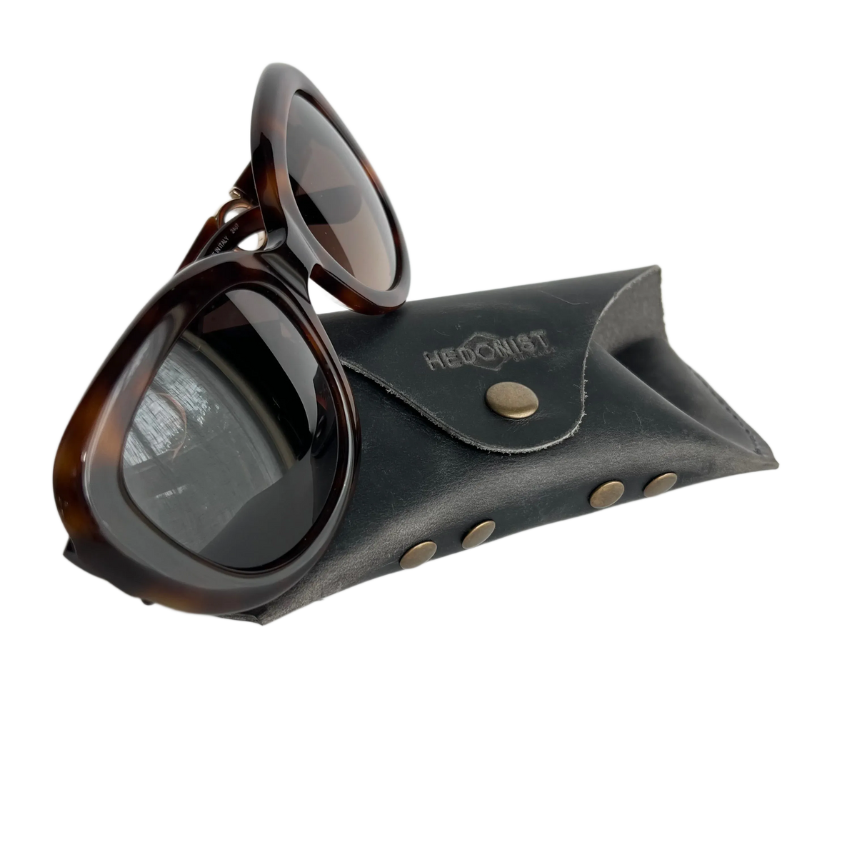 Soft Leather Eye Glasses Case in Black Washed with tortoiseshell sunglasses leaning against it