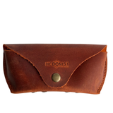 Soft Leather Eye Glasses Case in Cognac, closed, front view with embossed Hedonist logo and snap closure
