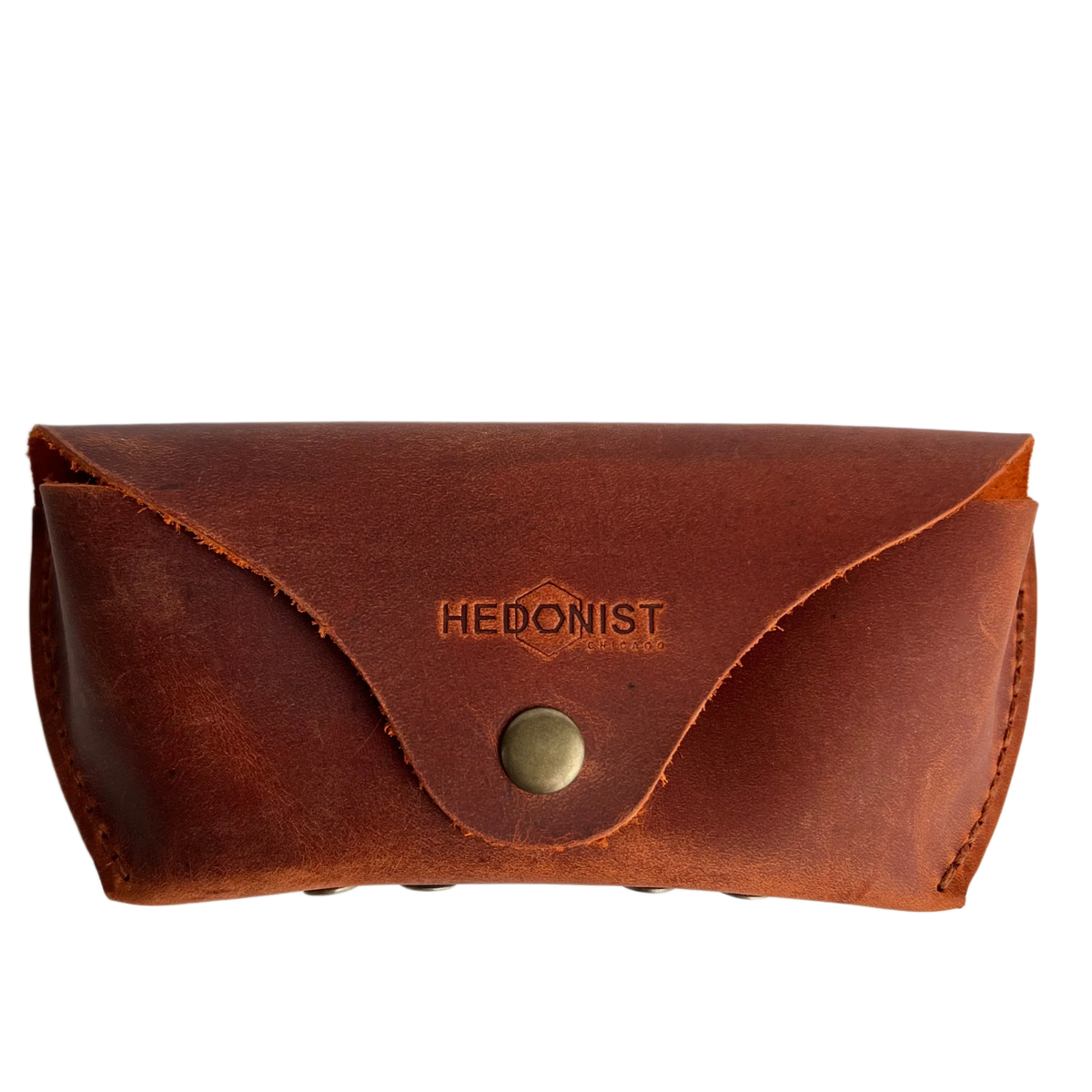 Soft Leather Eye Glasses Case in Cognac, closed, front view with embossed Hedonist logo and snap closure
