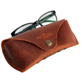 Soft Leather Eye Glasses Case in Cognac with black-framed eyeglasses resting on top