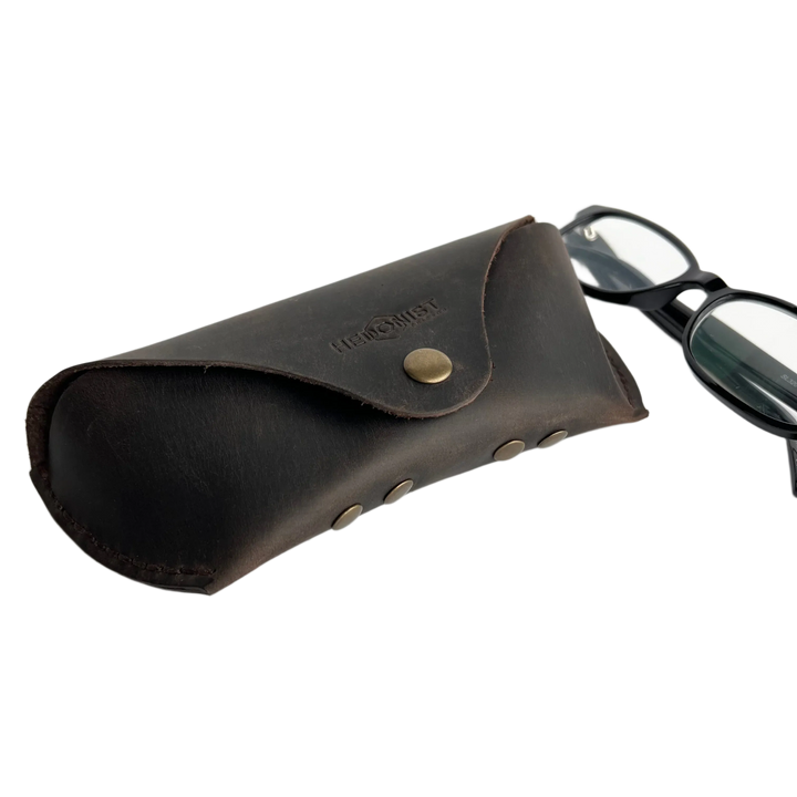 Soft Leather Eye Glasses Case in Dark Brown with black-framed eyeglasses beside it