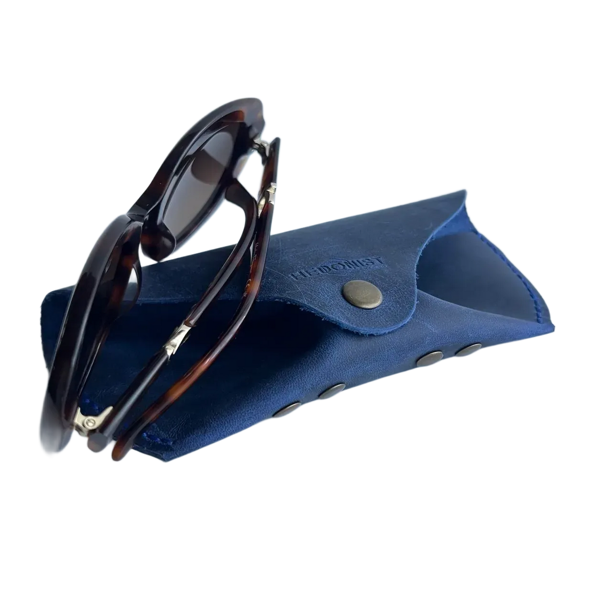 Soft Leather Eye Glasses Case in Navy Blue with tortoiseshell sunglasses resting on top