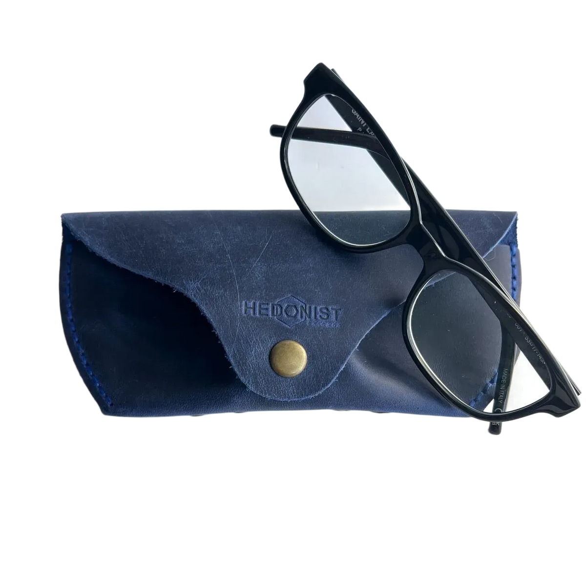 Soft Leather Eye Glasses Case in Navy Blue with black-framed eyeglasses resting on top