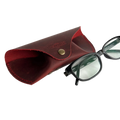 Soft Leather Eye Glasses Case in Red with black-framed eyeglasses resting beside it