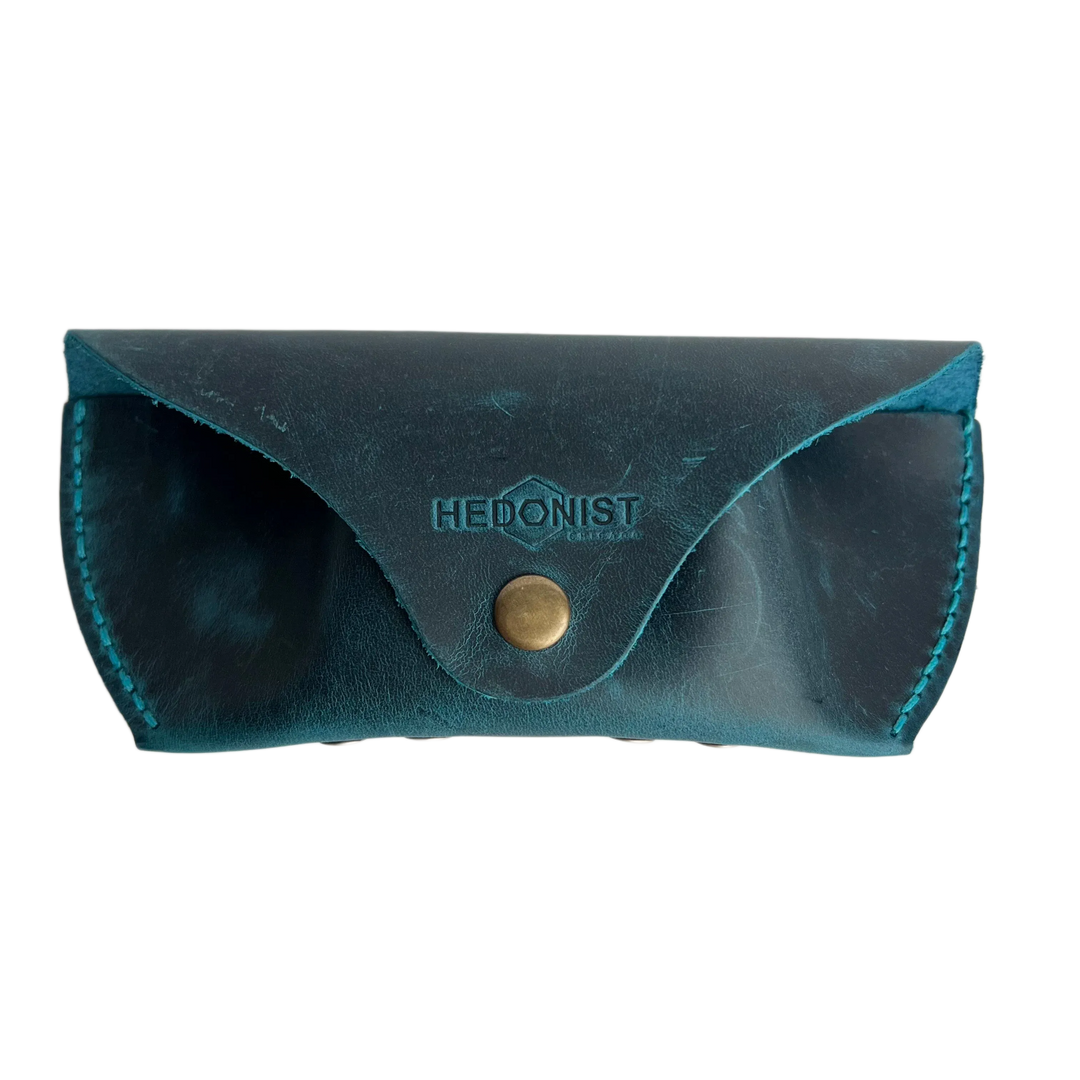 Soft Leather Eye Glasses Case in Teal, closed, front view with embossed Hedonist logo and snap closure