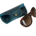 Soft Leather Eye Glasses Case in Teal with tortoiseshell sunglasses beside it
