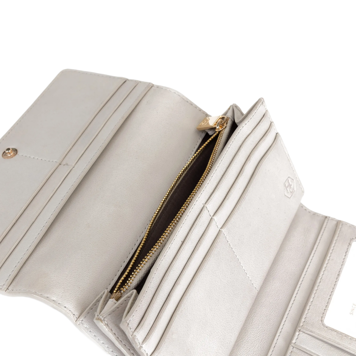 Gray leather trifold wallet open showing gold-tone hardware, coin pocket, and ID window