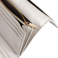 Close-up of gray leather trifold wallet showing card slots and gold zipper pull engraved with Hedonist Chicago