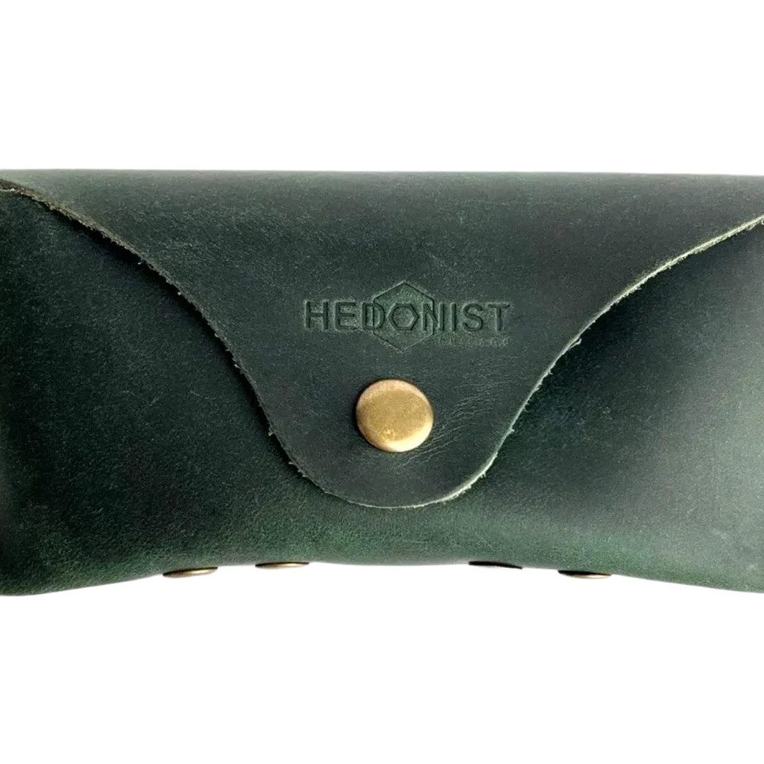 Soft Leather Eye Glasses Case in Dark Green, closed, front view with embossed Hedonist logo and snap closure