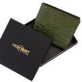 Green crocodile-embossed leather wallet displayed inside an open black presentation box with gold 'HEDONIST CHICAGO' branding on the lid, set against a plain white background.