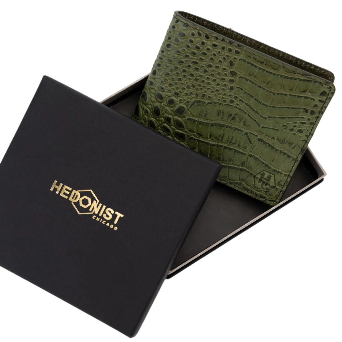 Green crocodile-embossed leather wallet displayed inside an open black presentation box with gold 'HEDONIST CHICAGO' branding on the lid, set against a plain white background.
