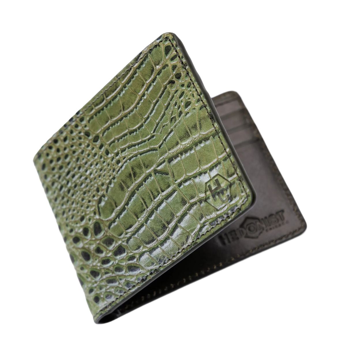 An olive green bifold wallet with a crocodile-embossed texture on the front cover, shown partially open to reveal a dark brown interior. 