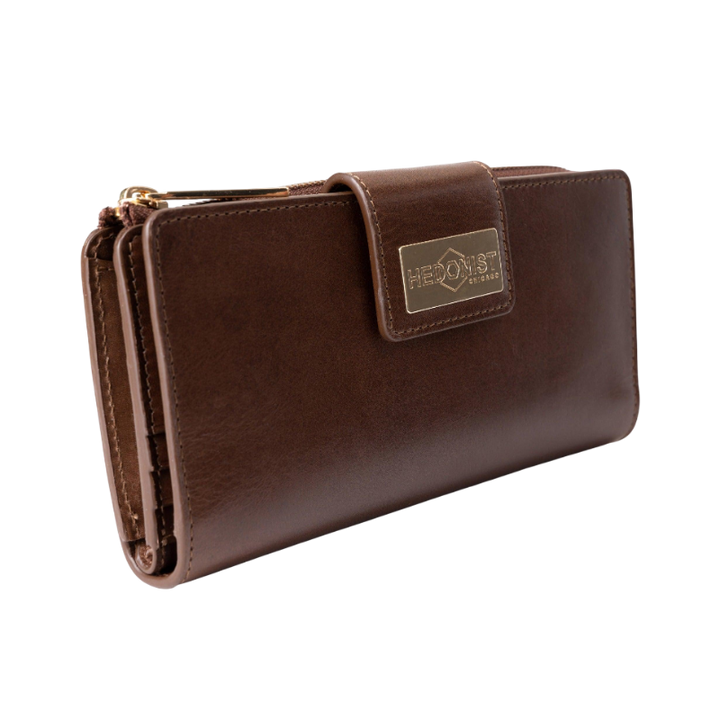Brown leather travel wallet closed, front view with gold-tone Hedonist Chicago plaque