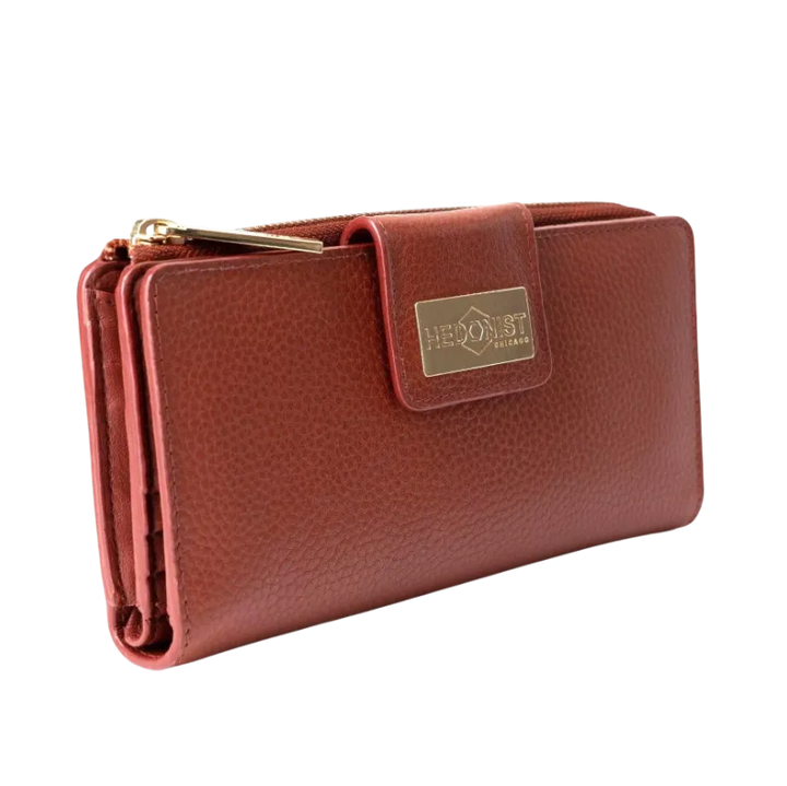 Large red pebbled leather travel wallet closed, front flap with gold-tone Hedonist Chicago plaque