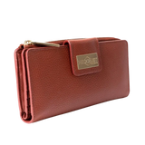 Large red pebbled leather travel wallet closed, front flap with gold-tone Hedonist Chicago plaque