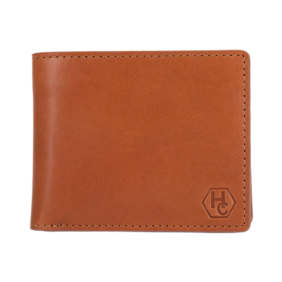 A brown leather bi-fold wallet with a debossed 'HC' logo in the bottom right corner, shown on a plain white background.