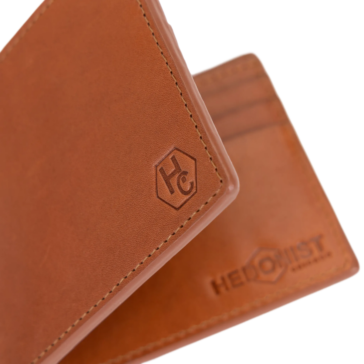 Close-up of the embossed logo on light brown leather bifold wallet interior