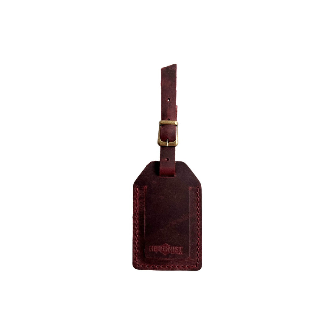 Handmade Leather Luggage Tag in Burgundy - closed front view with logo
