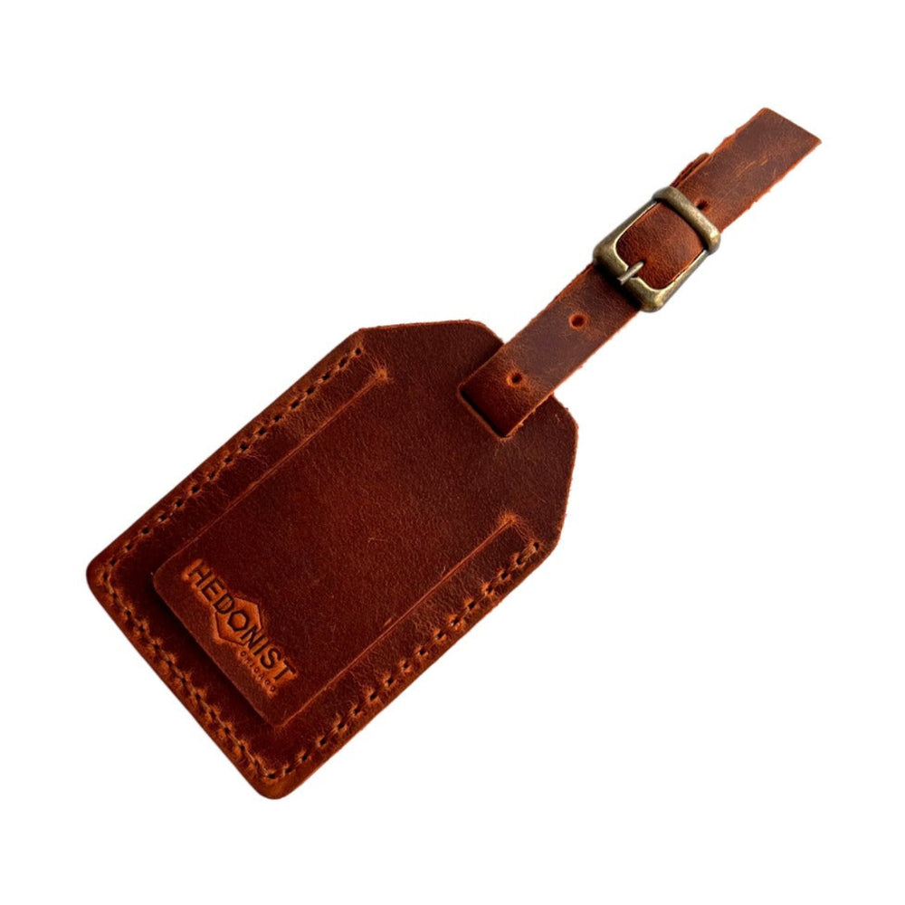 Handmade Leather Luggage Tag in Cognac - closed front view with logo