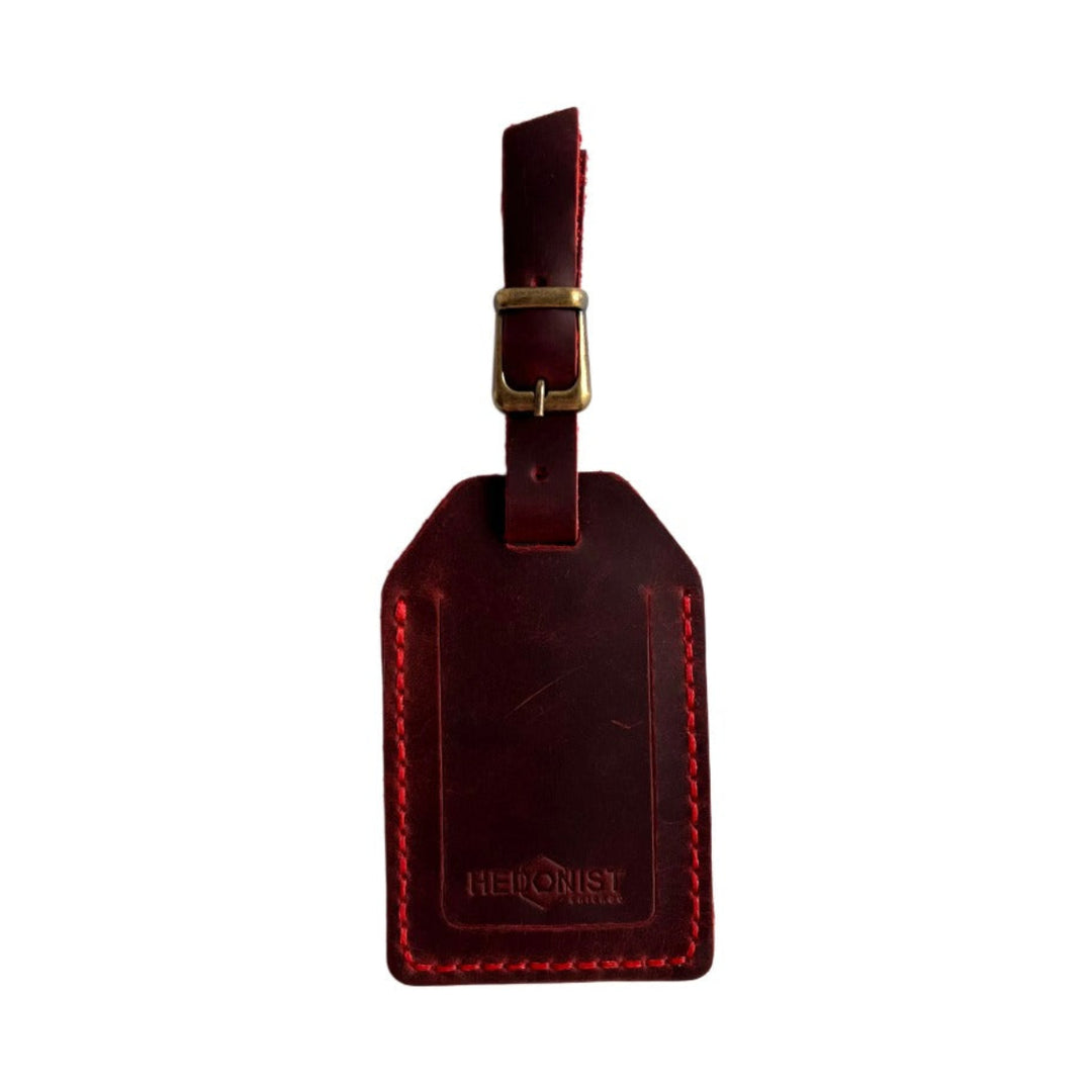 Handmade Leather Luggage Tag in Red - closed front view with logo