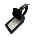 Black full-grain leather luggage tag with matching leather strap and brass buckle, shown on a light gray background.