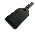Black washed full-grain leather luggage tag with white contrast stitching and brass buckle, embossed Hedonist Chicago logo on the front, shown on a white background.