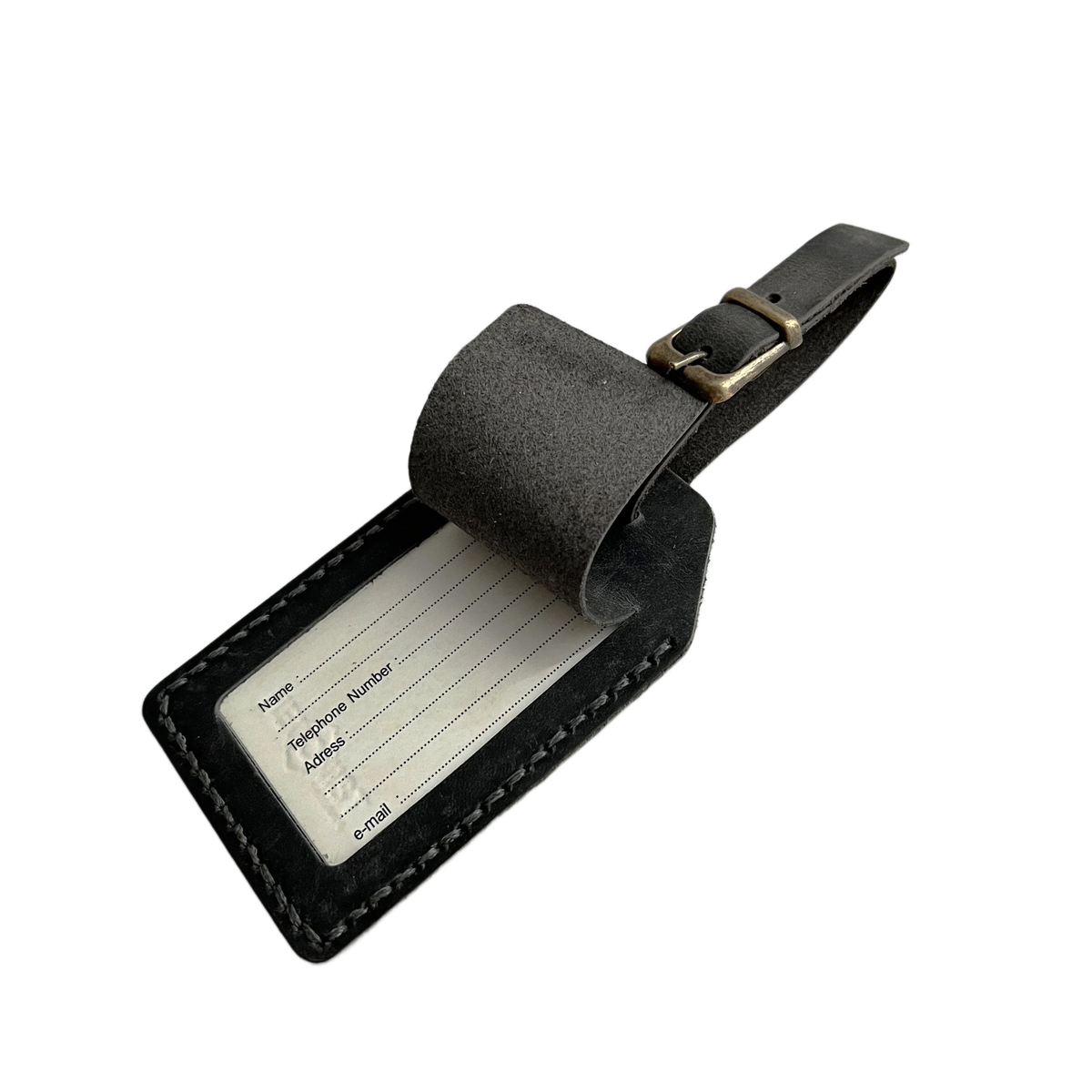 Black washed full-grain leather luggage tag with matching strap and brass buckle, shown on a light gray background.