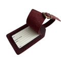 Burgundy full-grain leather luggage tag with matching adjustable strap and brass buckle, shown open on a light gray background.
