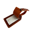 Cognac full-grain leather luggage tag with strap and brass buckle, shown with a printable ID insert card for name, phone, address, and email.