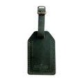Green full-grain leather luggage tag with brass buckle, embossed Hedonist Chicago logo on the front, shown on a light background.
