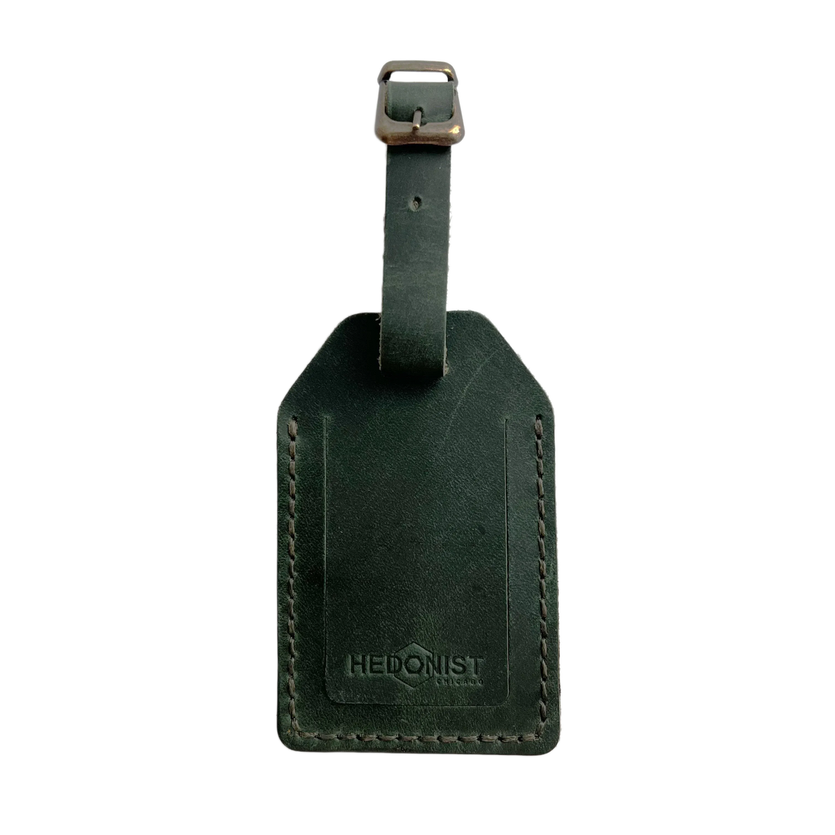 Green full-grain leather luggage tag with brass buckle, embossed Hedonist Chicago logo on the front, shown on a light background.