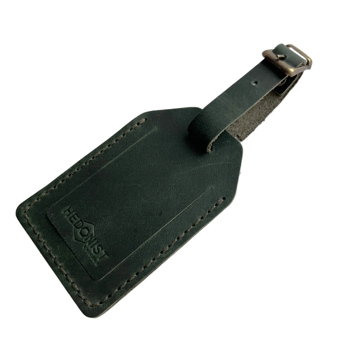 Green full-grain leather luggage tag with matching leather strap and brass buckle, embossed Hedonist Chicago logo on the front, shown on a light gray background.