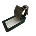 Green full-grain leather luggage tag with matching adjustable strap and brass buckle, shown on a white background.