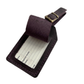 Plum full-grain leather luggage tag with matching adjustable strap and brass buckle, shown open to reveal a blank ID insert card, on a light background.
