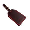 Red full-grain leather luggage tag with red stitching and brass buckle strap, embossed Hedonist Chicago logo on the front, shown on a white background.
