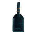 Teal full-grain leather luggage tag with matching leather strap and brass buckle, teal stitching, embossed Hedonist Chicago logo near the bottom, shown on a white background.