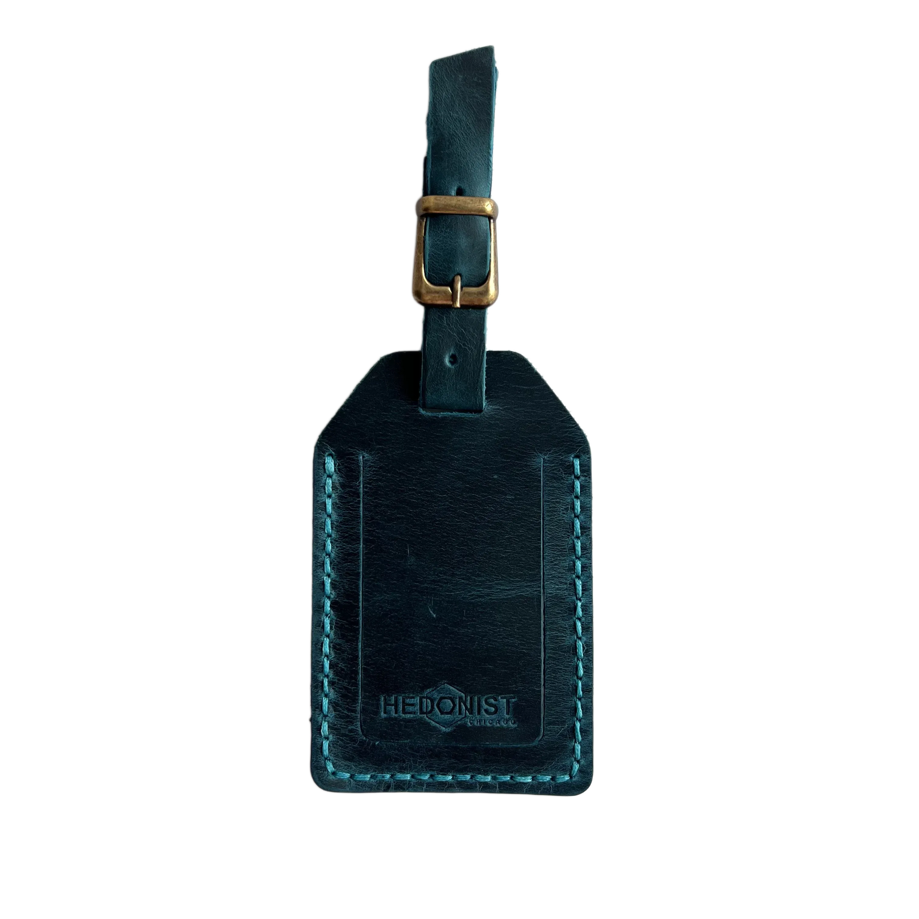 Teal full-grain leather luggage tag with matching leather strap and brass buckle, teal stitching, embossed Hedonist Chicago logo near the bottom, shown on a white background.