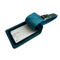 Teal full-grain leather luggage tag with matching strap and brass buckle, shown open with a printable ID insert card for name, phone, address, and email.