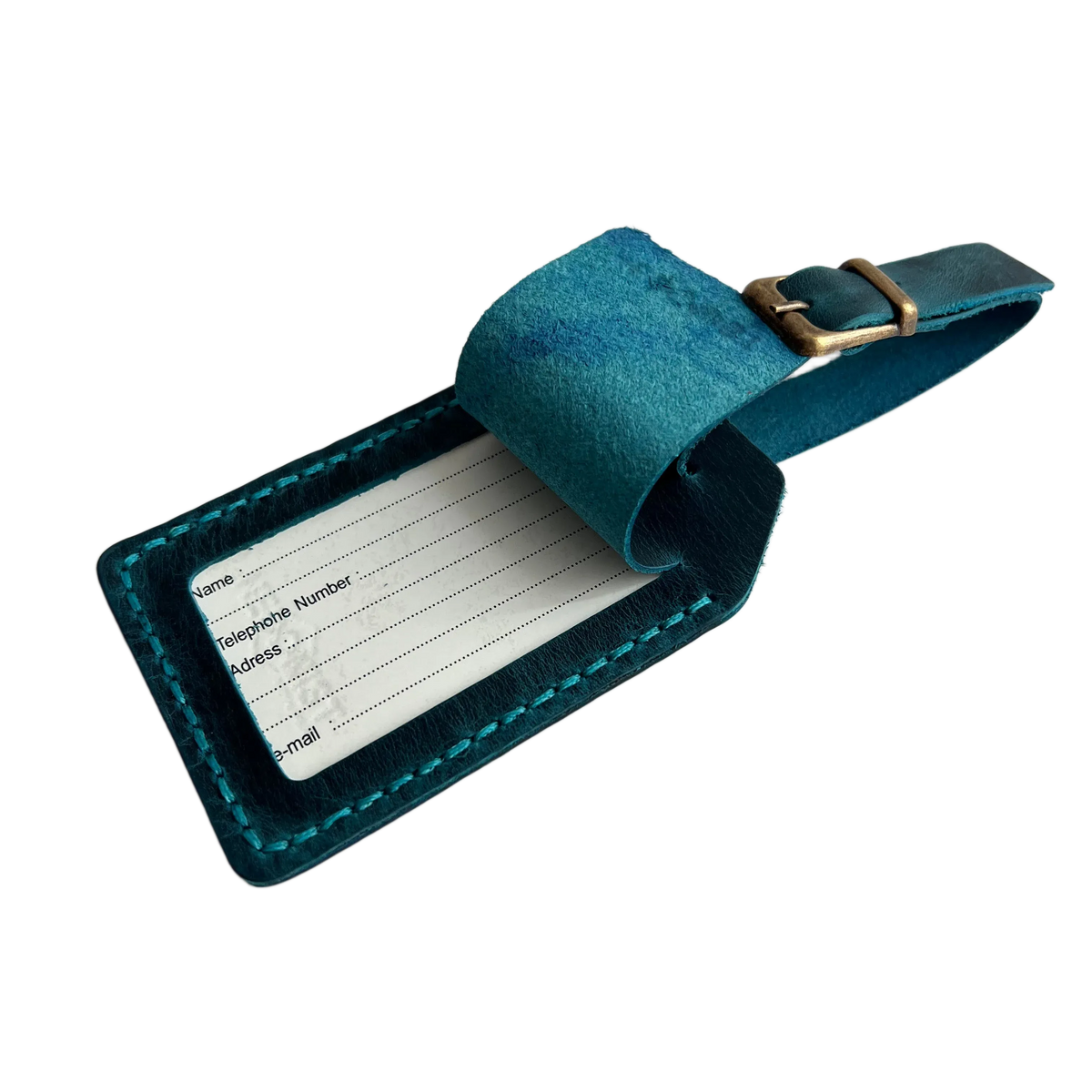 Teal full-grain leather luggage tag with matching strap and brass buckle, shown open with a printable ID insert card for name, phone, address, and email.