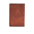 Hedonist Chicago light mahogany passport case in light mahogany, travel cover, full grain leather, angled view