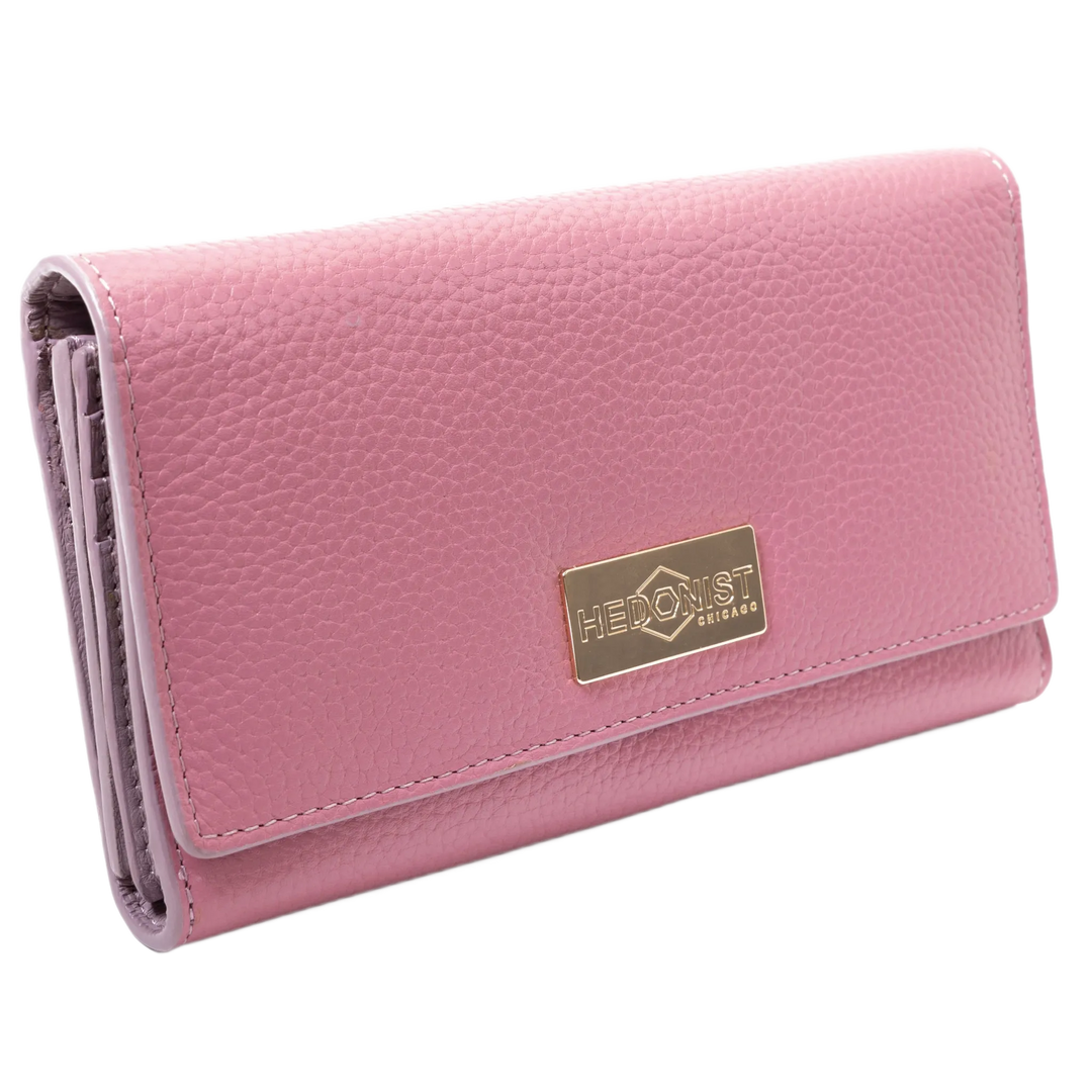 Pink leather trifold wallet for women closed, gold-tone Hedonist Chicago plaque on front
